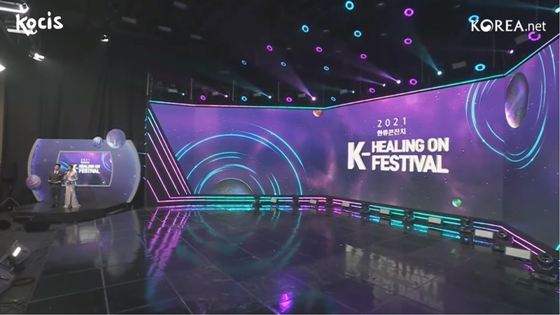 Sự kiện K-Healing On Festival 2021 tổ chức bởi Trung tâm Văn hóa và Thông tin Hàn Quốc (KOCIS) có thiết kế sân khấu tối giản nhưng không kém phần sang trọng, tinh tế thể hiện qua các gam màu chủ đạo như tím, xanh, trắng. (Ảnh: Chụp màn hình từ livestream trên kênh YouTube chính thức của Korea.net)