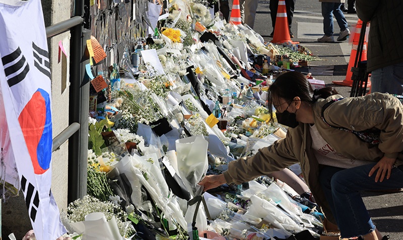 Une citoyenne dépose une fleur à la sortie 1 de la station de métro Itaewon afin de rendre hommage aux personnes décédées dans la bousculade à Itaewon dans le district de Yongsan, à Séoul, le 2 novembre 2022.
