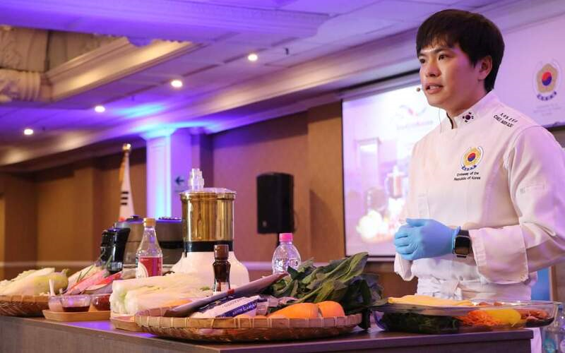 El chef de la Embajada de Corea en Perú, Ilso Moon, explica cómo preparar kimchi y kimbap, durante la feria educativa 'Study in Korea 2023', llevada a cabo en el salón Le Meridien del Hotel Sheraton, ubicado en el centro histórico de la ciudad de Lima, en Perú. | Embajada de Corea del Sur en Perú 