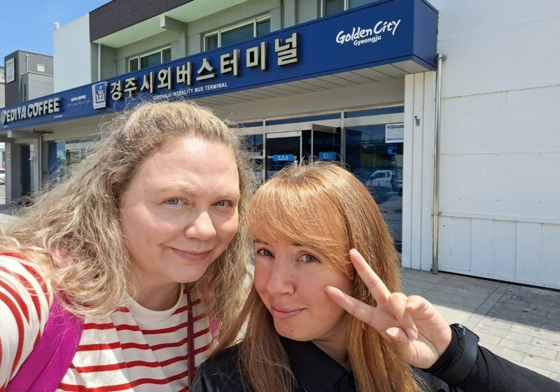 Слева направо: Дарья Дудко и Дана Пак на фоне автовокзала в Кёнджу. / Фото: Дана Пак