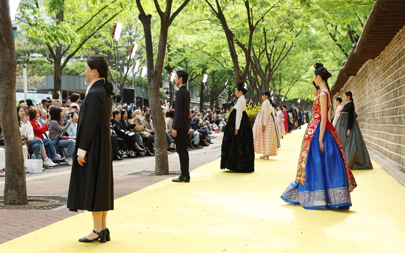 Designer Kwon Hyejin from Hanbok Studio Hyeon and her models bow to the audience after their show, receiving applause.  