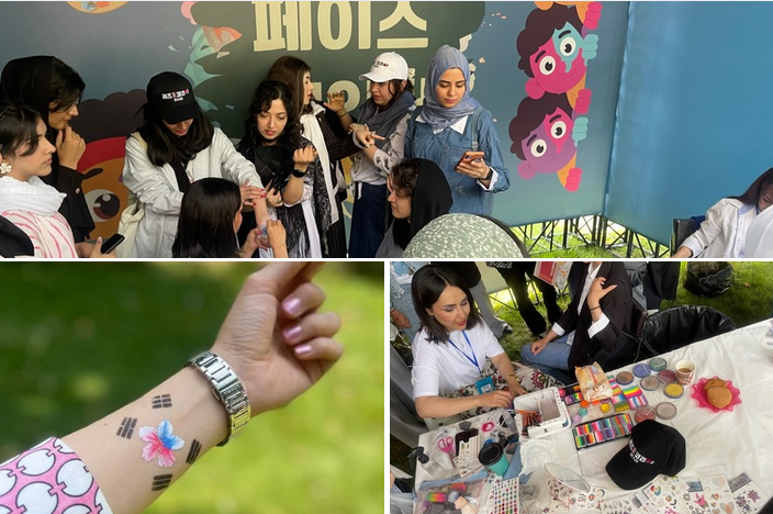 Gesichtsbemalungsstand mit koreanischen Symbolen